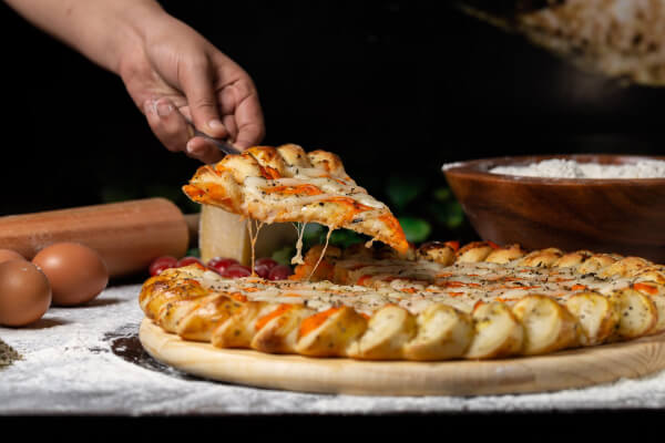 Close up shot of a pizza slice getting picked up