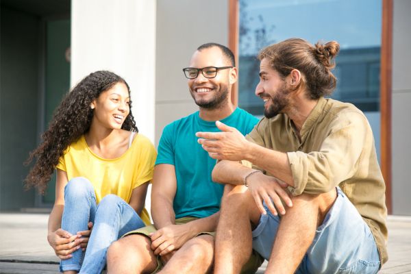 A group of people smiling while talking